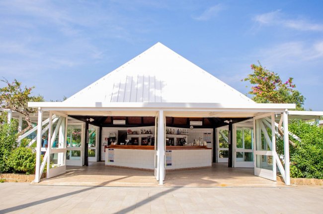 Chiosco bianco all'aperto con tetto a capanna.