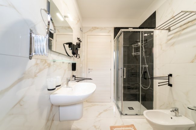 Bagno moderno con doccia in vetro.