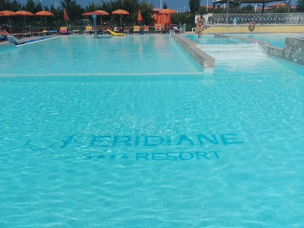 Piscina con ombrelloni arancioni.